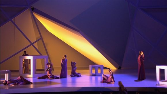 The stage with white cubes under a slanted golden light